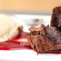 Chocolate fudge pudding with berry sauce and vanilla pod ice cream