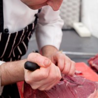 Chef butchering steak